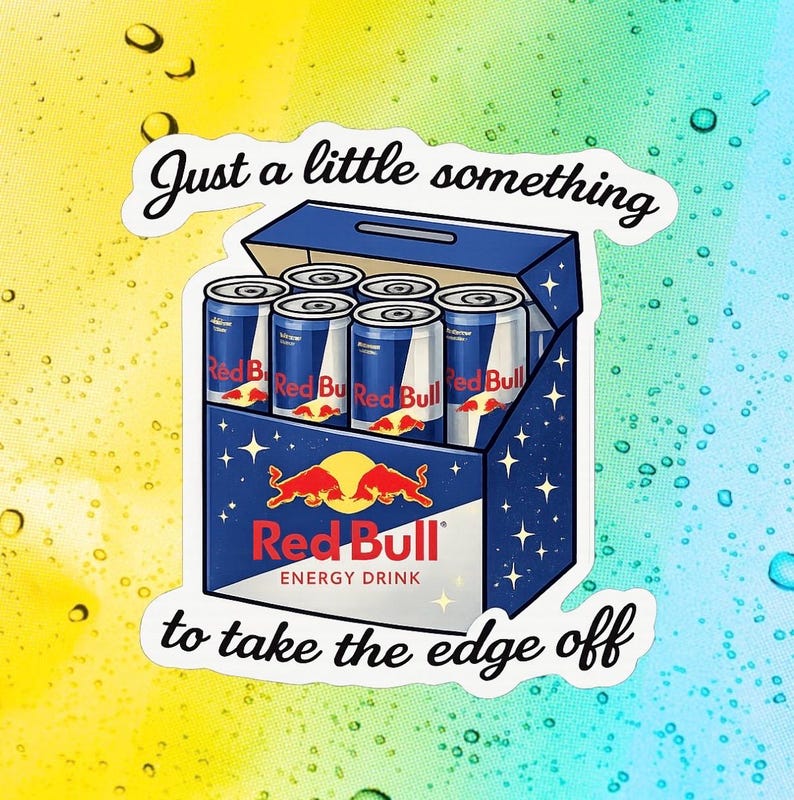May include: A sticker depicting a six-pack of Red Bull energy drink cans in a blue box. The Red Bull logo is visible, with the text "Just a little something to take the edge off."