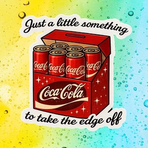 May include: A sticker depicting a red Coca-Cola box containing six red cans. The Coca-Cola logo is visible. The text "Just a little something to take the edge off" is written above and below the box in a cursive font.