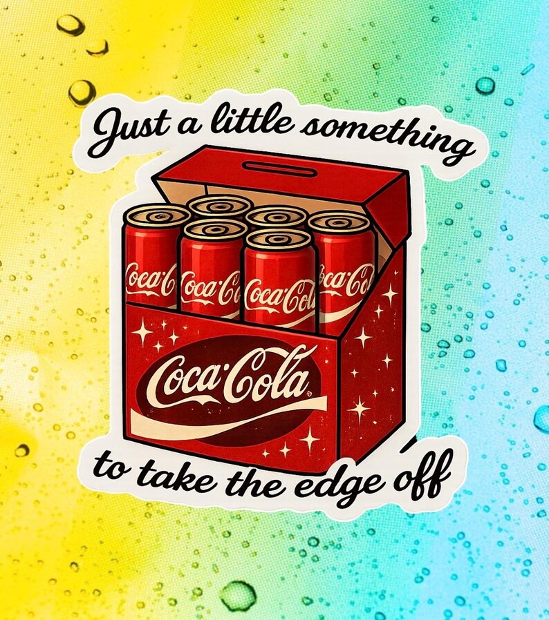 May include: A sticker depicting a red Coca-Cola box containing six red cans. The Coca-Cola logo is visible. The text "Just a little something to take the edge off" is written above and below the box in a cursive font.