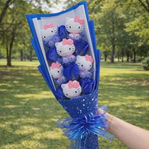 May include: A bouquet of blue roses and Hello Kitty figurines wrapped in blue paper and tied with a blue ribbon. The bouquet features white Hello Kitty figures with pink bows and blue rose blooms, creating a cheerful and colorful arrangement.
