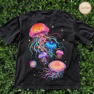 May include: Black t-shirt featuring a vibrant illustration of several colorful jellyfish. The jellyfish are depicted in shades of pink, orange, blue, and purple, with long, flowing tentacles. The design includes stars and a crescent moon.