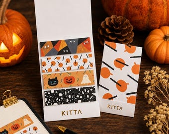 May include: A set of Kitta brand adhesive paper strips featuring four distinct Halloween-themed patterns including geometric shapes with eyes, orange pumpkins, black cats, and white ghosts, alongside a matching folded card with orange pumpkin motifs.
