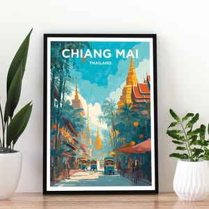 May include: A framed travel poster featuring a vibrant illustration of a street scene in Chiang Mai, Thailand. The artwork displays golden temples, lush palm trees, and blue tuk-tuks under a bright sky, with the text CHIANG MAI THAILAND at the top.