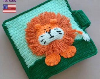 May include: A crocheted lion-themed blanket in green and orange. The blanket features a detailed lion's face with an orange mane, white muzzle, and black eyes. The text "CROCHET PATTERN" is in the upper left corner, with the American flag.