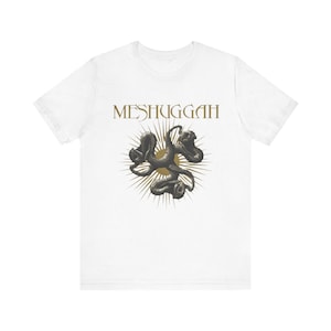 May include: A white short-sleeve t-shirt featuring the text MESHUGGAH in gold lettering above a graphic of three intertwined dark grey snakes centered over a gold sunburst design. The shirt has a crew neckline and a standard straight hemline.