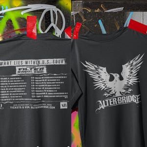 May include: Dark gray t-shirts with tour dates and band logos. One shirt features the text "WHAT LIES WITHIN U.S. TOUR" and the bands Filter and Sevendust. The other shirt displays an eagle graphic and the band name Alter Bridge.