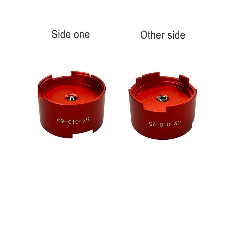 two red metal objects, each with a hole in the center, labeled with numbers and text. The objects are positioned side by side, with one labeled "Side one" and the other labeled "Other side".