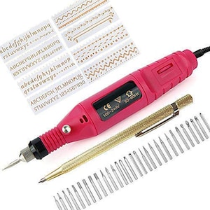 May include: A pink rotary tool kit with a gold-colored pen-like attachment and various drill bits. Includes stencils with alphabet letters and decorative patterns. The tool has a black power cord and a black display.
