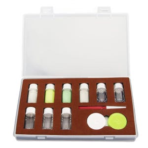 May include: A clear plastic case containing small glass vials with white caps, some filled with colored liquids. Also included are a red applicator stick, a white contact lens case, and a green contact lens case.