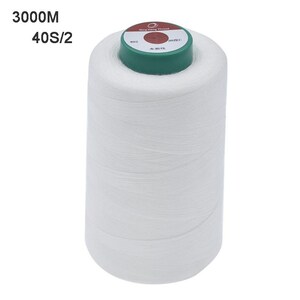 May include: A large spool of white sewing thread. The spool has a green top with text and a red circle. The text "3000M 40S/2" is printed on the upper left side of the image.