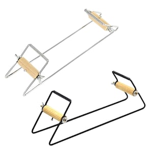 May include: Two weaving looms are displayed against a white background. One loom is silver with a wooden handle, and the other is black with a wooden handle. The looms are designed for crafting and textile projects.