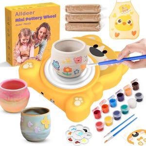 May include: A yellow Alldeer mini pottery wheel kit, model PW201, featuring a bear-shaped base, three blocks of clay, a yellow apron with a chick graphic, paint pots, brushes, a palette, and two finished ceramic pots decorated with colourful stickers.