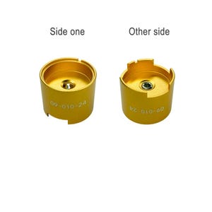two different views of a gold-colored metal object, possibly a tool or device, with the text "Side one" and "Other side" indicating the orientation of the object.