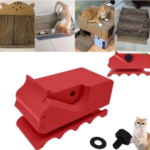 May include: A red plastic cat-shaped tool for assembling cardboard scratchers, featuring a sculpted feline head silhouette, a central circular opening, and a scalloped base. Includes a separate black threaded bolt and a flat circular washer.