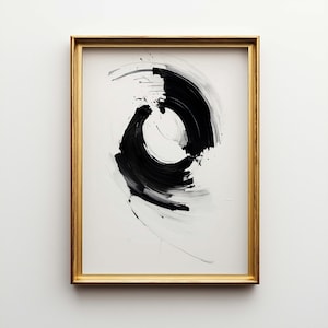 May include: Abstract art print in a gold frame. The artwork features bold black brushstrokes on a white background, creating a dynamic circular design. The gold frame adds a touch of elegance to the modern art piece.