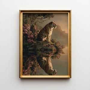 Puede incluir: Impresión artística enmarcada que muestra un tigre sentado en una roca junto al agua. El tigre es marrón y negro con vientre blanco. La obra de arte tiene un marco dorado y representa un paisaje sereno con flores rosas y un árbol.