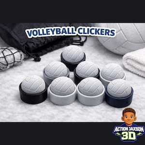 Puede incluir: Un conjunto de clickers de voleibol, cada uno con un diseño de balón blanco, colocados en bases negras, grises y azul marino. La imagen incluye un balón de voleibol, una toalla y el texto "VOLLEYBALL CLICKERS".