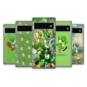 May include: A collection of five phone cases featuring the character Yoshi from the Super Mario video game series. The cases are primarily green, with various designs including Yoshi holding an apple, Yoshi patterns, and Yoshi in action poses.