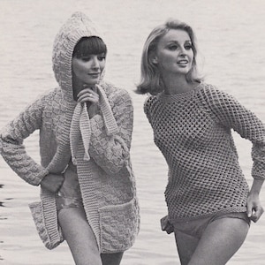 May include: Monochrome image of two women in knitted outfits. One wears a hooded cardigan, the other a mesh top. The image includes the text "SURFER" and "SKIMMER". The women are standing on a wooden pier.