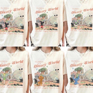 May include: Cream-colored t-shirts featuring a vintage-style graphic of Florida's Disney World. The design includes the park's name, a castle, and various Disney characters. The text "The Most Magical Place On Earth" is also present.
