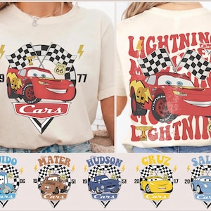 May include: A cream-coloured t-shirt with a red cartoon race car, number 95, and checkered flags. The front says "Cars", the back says "Lightning McQueen" and "Route 66". Below are images of other Cars characters.