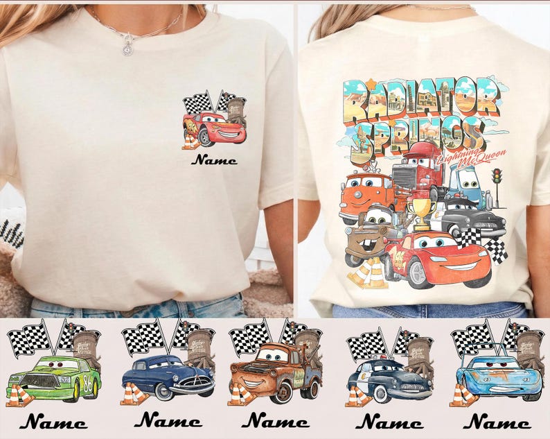 May include: Cream-colored t-shirt featuring a Cars movie design. The front has a small graphic of Lightning McQueen with flags. The back displays a larger design with various Cars characters and the text "Radiator Springs".