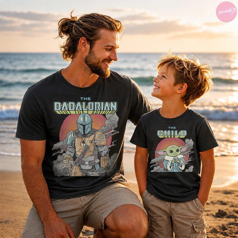 May include: Two black t-shirts with matching graphics. One shirt says "The Dadalorian" with a Mandalorian graphic, the other says "The Child" with a Grogu graphic. Both shirts have a retro sunset design.