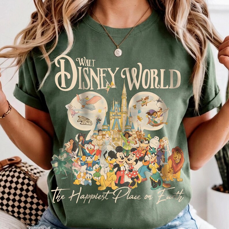 May include: Green t-shirt featuring a graphic of Disney World characters and the text "Walt Disney World" and "The Happiest Place on Earth". The design includes Mickey Mouse, Donald Duck, and other beloved characters.