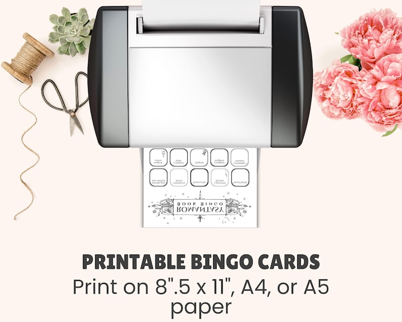 May include: A printer is shown with a printed bingo card. The card has a banner that says "BOOK BINGO" in reverse. The text at the bottom says "PRINTABLE BINGO CARDS" and "Print on 8".5 x 11", A4, or A5 paper".