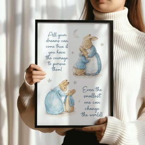 May include: A framed print with illustrations of rabbits in blue outfits. The text reads: "All your dreams can come true if you have the courage to pursue them!" and "Even the smallest one can change the world!"