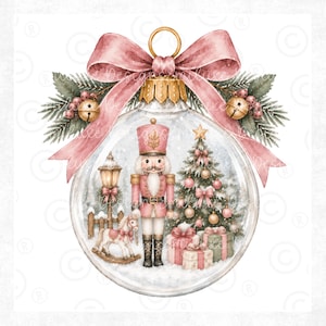 May include: A clear glass Christmas ornament featuring a pink nutcracker, a decorated tree with pink ornaments, a rocking horse, and a street lamp. The ornament is topped with a large pink bow, green pine sprigs, and two small gold jingle bells.