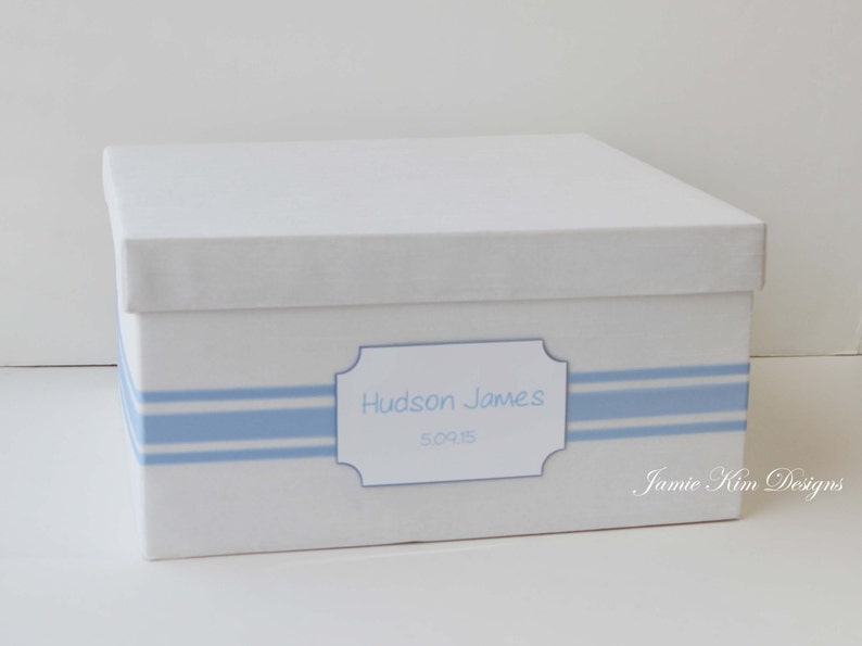 May include: White keepsake box with blue and white striped trim and a label that reads "Hudson James  Sorts".