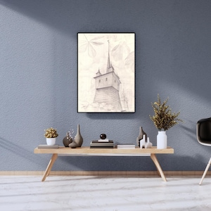 May include: A framed pencil sketch of a tall tower with a spire, set against a backdrop of stylized leaves. The artwork is displayed above a wooden table with decorative vases and a small plant.