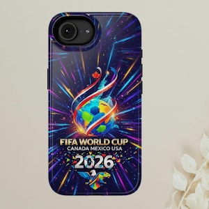 May include: A dark blue phone case featuring the FIFA World Cup 2026 logo. The design includes a globe with a soccer ball, ribbons, and the text "FIFA WORLD CUP CANADA MEXICO USA 2026". The case has a glossy finish.