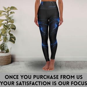 May include: Black leggings with a high waistband and a blue lightning bolt design. The word "Should" is printed in blue on the waistband. The text at the bottom of the image reads "ONCE YOU PURCHASE FROM US YOUR SATISFACTION IS OUR FOCUS."