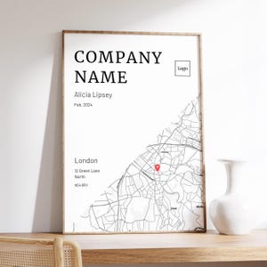 May include: A framed map print of London, with a red marker indicating a location. The print displays "COMPANY NAME," "Alicia Lipsey," and "Feb. 2024." The address "12 Green Lane, North, N54 6RV" is also shown, along with a logo.