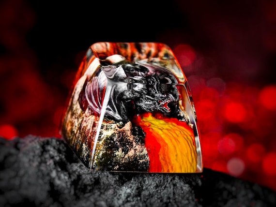 A hand-sculpted resin fire dragon erupting from your keycap — tiny mythical art you actually type on every day.