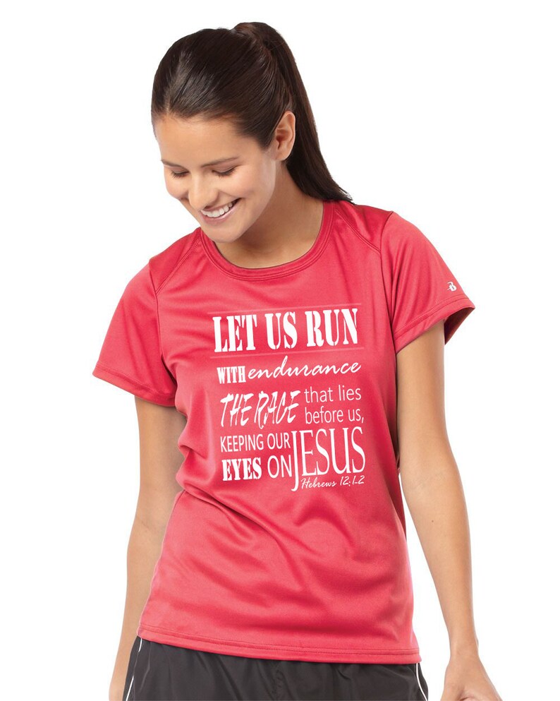 May include: Red short-sleeved running shirt with white text that reads "Let us run with endurance the race that lies before us, keeping our eyes on Jesus, Hebrews 12:12".