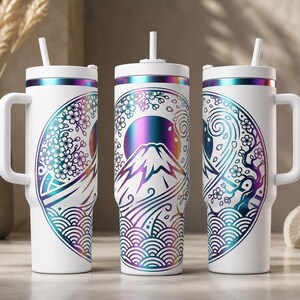 May include: White insulated tumbler with a handle and straw, featuring a Japanese-inspired design. The design includes a mountain, cherry blossoms, and waves in shades of purple, blue, and teal. The tumbler has a white lid and handle.