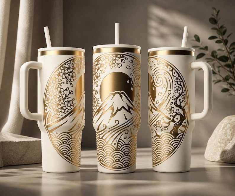 May include: Three white insulated tumblers with gold Japanese-inspired designs. Each tumbler features a handle, a straw, and a gold lid. The designs include Mount Fuji, cherry blossoms, and wave patterns. The tumblers are ideal for hot or cold beverages.
