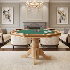 May include: A wooden poker table with a green felt surface. The table has a light brown finish and a unique octagonal shape. Poker chips and playing cards are visible on the table. The table is supported by a pedestal base and is set in a living room.