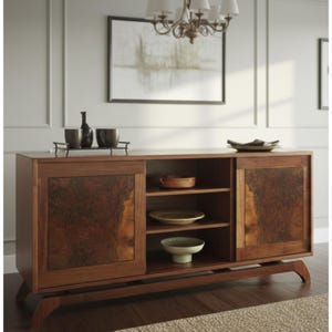 May include: A wooden sideboard with sliding doors and a mid-century modern design. The doors feature a unique wood grain pattern. The interior has shelves for storage. The top holds a tray with cups and a bottle.