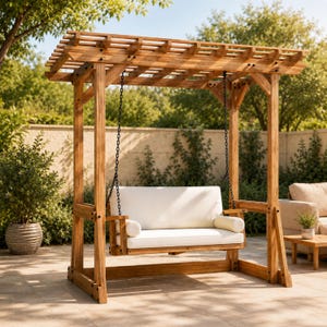 May include: A wooden swing set with a pergola-style roof. The swing features a white cushion and armrests, suspended by black chains. The structure is made of light brown wood and is set outdoors.