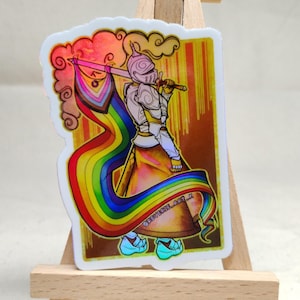 May include: A sticker featuring a knight holding a rainbow flag and sword. The knight is wearing armor and a helmet, with a flowing rainbow banner. The background has a gold and orange color scheme with the text "REVECA_ART_Z".