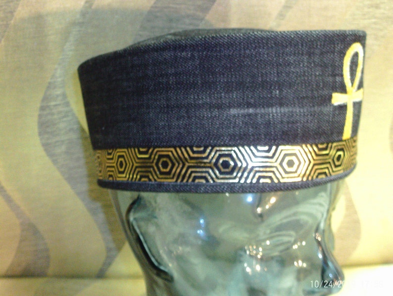 Completely Handmade from Black Denim this crown is custom designed the a Gold Egypt Ankh front and Center and completed with gold ribbon.