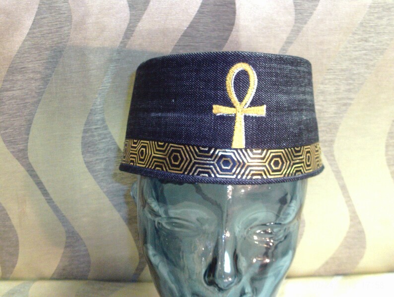 Completely Handmade from Black Denim this crown is custom designed the a Gold Egypt Ankh front and Center and completed with gold ribbon.