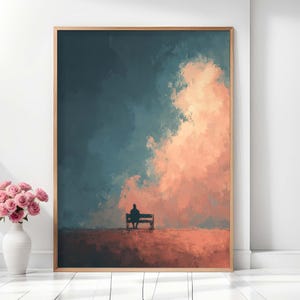 Puede incluir: Una impresión artística enmarcada representa una figura solitaria sentada en un banco, sobre un fondo de un cielo dramático. La obra de arte presenta una mezcla de tonos turquesa y melocotón, creando un paisaje sereno y evocador. El marco de madera añade calidez a la composición.
