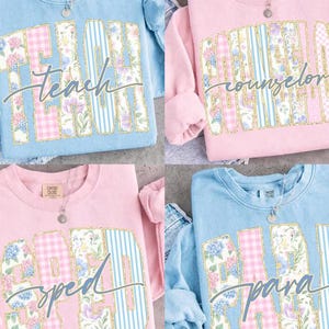 May include: Four crewneck sweatshirts in light blue and soft pink, each featuring a large block-letter applique with floral, gingham, and striped patterns. The text reads "teach", "counselor", "sped", and "para" in a cursive script overlay.