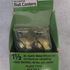May include: A green and white Sears box containing two decorative ball casters. The box reads "DECORATIVE Ball Casters" and "1 1/2 IN. DIAM. Metal Wheel for furniture on carpeting". Each caster has a load rating of 40 lbs. per caster.