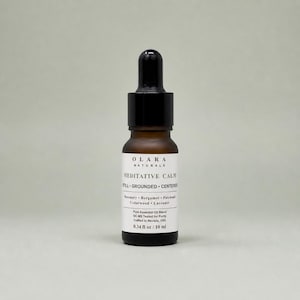 May include: A brown glass bottle of essential oil with a black dropper. The label reads "OLARA NATURALS MEDITATIVE CALM." The bottle contains 0.34 fl oz / 10 ml of essential oil. The ingredients include rosemary, bergamot, patchouli, cedarwood, and lavender.